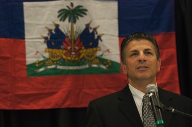 With the Haitian flag behind him, physician Steven Falcone gives details on the Miller School's medical relief efforts in Haiti.