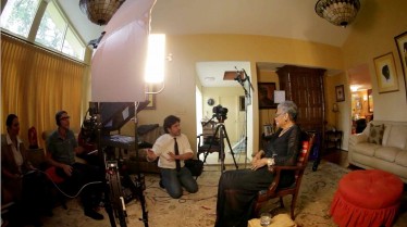 On location in Winston Salem: Maya Angelou is interviewed in her home by Ali Habashi (kneeling). Seated on the couch are Ed Talavera and Christina Delphus, associate director of the Arnold Center.