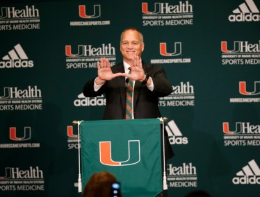 It's official: Mark Richt makes the popular U sign during at his introductory press conference as UM's new head football coach.